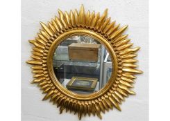 A decorative modern gilt framed mirror in art deco