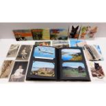 A postcard album with approx. 52 cards & a small s