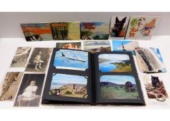 A postcard album with approx. 52 cards & a small s