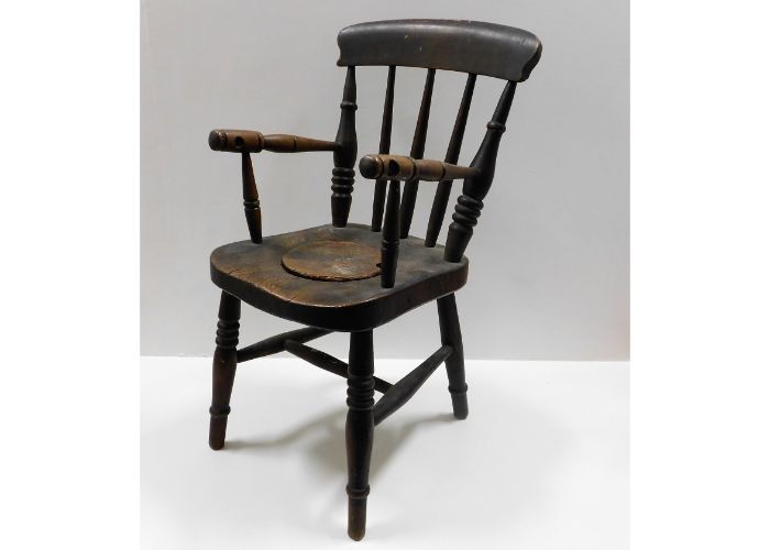 A 19thC. elm child's potty chair