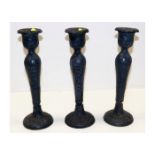 Three cast iron candle holders with relief decor p
