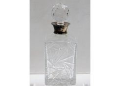 A silver topped glass decanter