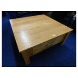 A modern oak low level coffee table with drawer un