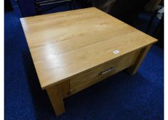 A modern oak low level coffee table with drawer un