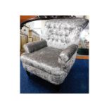 A small reupholstered button backed armchair with