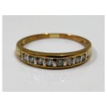 A yellow metal half eternity ring set with 0.25ct