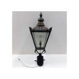 An antique copper gas lamp, later converted to ele
