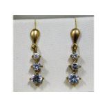 A pair of 9ct gold drop earrings with white stones