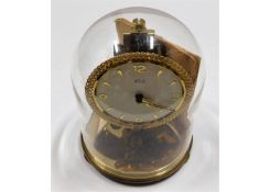 A Kundo anniversary style clock with glass dome