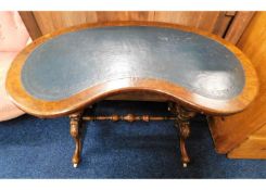 A Victorian kidney shaped walnut table with decora