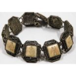 An Oriental white metal bracelet with bone inserts