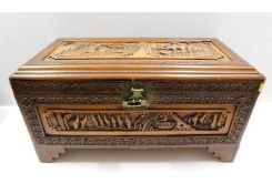 A carved Oriental camphor wood chest, fault to loc