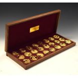 Collection of twenty-four silver gilt medallions issued by The Danbury Mint commemorating the Life