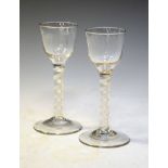 Two George III-style air-twist cordial glasses, each with rounded funnel bowl over single series