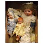 Large early 20th Century bisque head doll, the girl having blond hair with bow, wearing a blue and