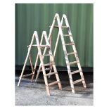 Two pairs of wooden folding step ladders