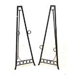 Pair of wrought iron easel stands, 133cm high