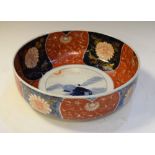 Imari bowl decorated with figure and a carp, the border with alternate iron red and underglaze