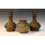 Matched pair of copper flasks having engraved decoration of foliage, 22cm high and a smaller squat