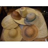 Collection of straw, cane and seagrass hats, together with a Colonial-style pith helmet