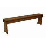 19th Century pine bench of pegged construction on shaped end standards, 166cm long