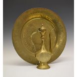 Middle Eastern brass charger with Arabic script, 42cm diameter and similar ewer, 31cm high