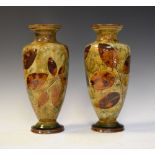 Pair of Doulton Lambeth stoneware baluster shaped vases having decoration of autumn leaves,