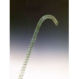 Nailsea-type green glass walking stick or cane of twisted design, 136cm long