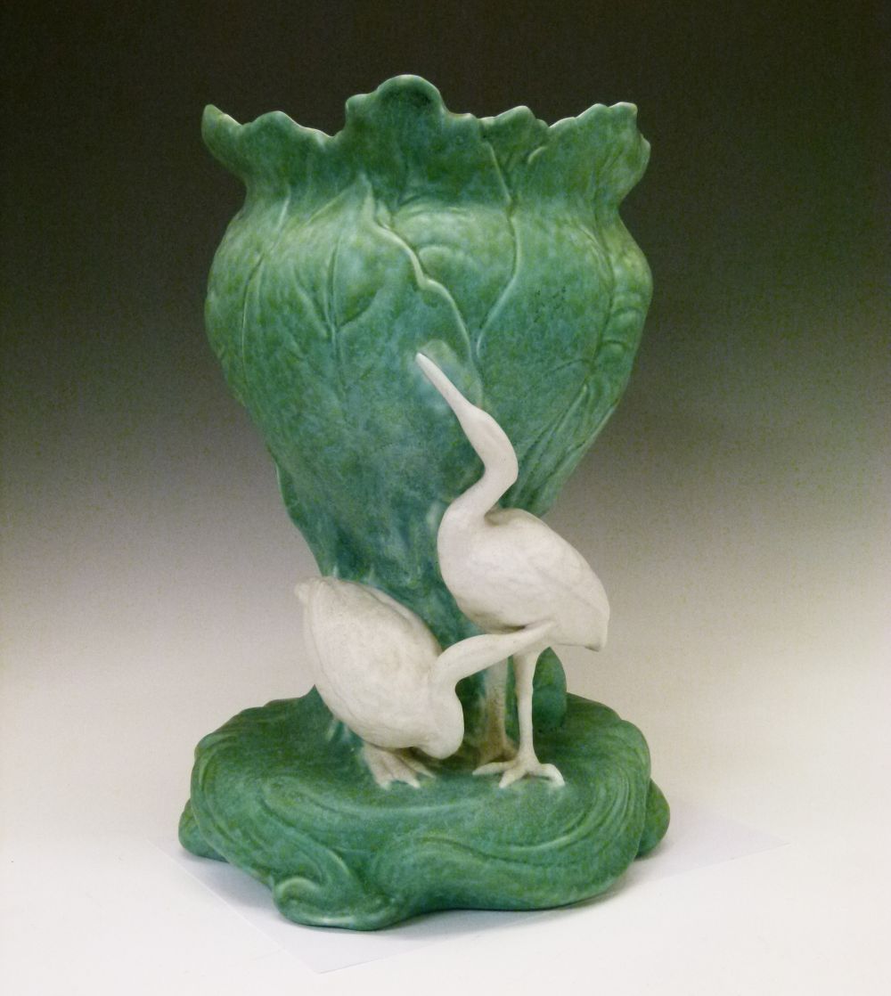 Bretby pottery jardinière, the leaf moulded central section surrounded by three white cranes,