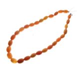 String of amber beads, the largest (central) measuring 12mm x 10mm approx, 16.6g approx, 37cm long