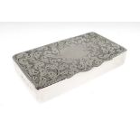 Late Victorian silver snuff box, the oblong cover with shaped front edge and foliate scroll