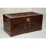 Carved camphor wood chest, the hinged cover with decoration of dragons chasing a flaming pearl, 99cm