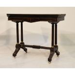 Victorian ebonised and string inlaid fold-over card table having red baize, raised on twin column