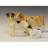 Melba ware Jersey cow, 18.5cm high, together with two Jack Russell Terriers (3)