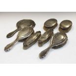 Set of five George V silver-backed dressing table items comprising hand mirror, pair of hand brushes