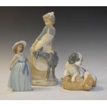 Three Spanish porcelain figurines, Nao girl with goat, 30cm high, Nao puppies and Lladro girl (3)