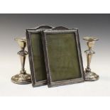 Pair of George V silver photograph frames, one with easel back, the silk backing stamped Simons & Co