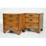 Pair of reproduction yew wood Military style campaign bedside chests of three drawers, fitted