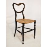 Victorian lacquered buckle back bedroom chair having caned seat, decorated with chinoiserie scenes