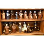 Large collection of monk design pottery decanters and liqueur sets