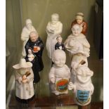 Three Royal Worcester porcelain candlesnuffers comprising a monk and two nuns, together with two