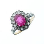 9ct gold, ruby and diamond dress ring, central facetted oval ruby within a border of twelve small