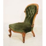 Victorian walnut framed spoon back salon chair having green upholstery