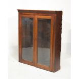 19th Century mahogany cabinet fitted three shelves enclosed by a pair of glazed doors, 105cm wide