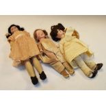 Three early 20th Century bisque headed dolls, all wearing dresses, tallest 30cm high