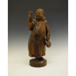 Carved wooden figure of a merry monk, 53cm high