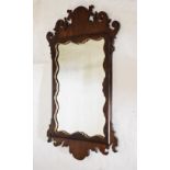 19th Century mahogany fretwork mirror having gilt gesso wavy border, 81cm high