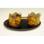 Oval and gilt decorated papier-mâché tray, and a pair of metal coasters, the tray 36cm wide