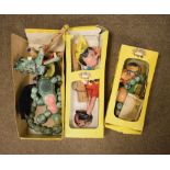 Three boxed Pelham Puppets comprising A3 Baby Dragon, A1 Mother Dragon, and SL7 Pinocchio