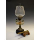 Late 19th/early 20th Century oil lamp having facet cut clear glass reservoir on black ceramic base